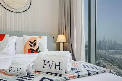 a hotel room with a bed with towels on it at PVH Stylish Boho 1BR with Study - The Crest in Dubai