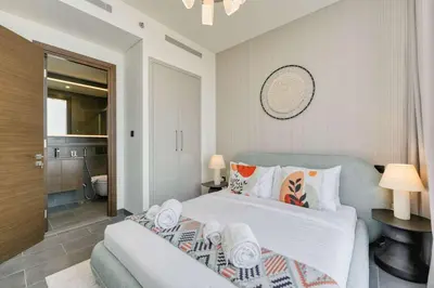a bedroom with a bed and a bathroom at PVH Stylish Boho 1BR with Study - The Crest in Dubai