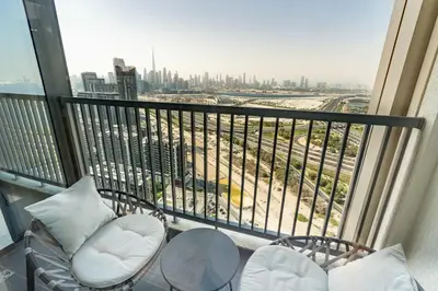 a balcony with chairs and a view of a city at PVH Stylish Boho 1BR with Study - The Crest in Dubai