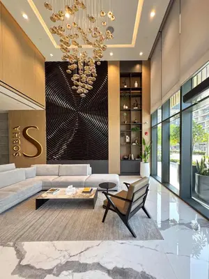 a living room with a couch and a chandelier at PVH Stylish Boho 1BR with Study - The Crest in Dubai