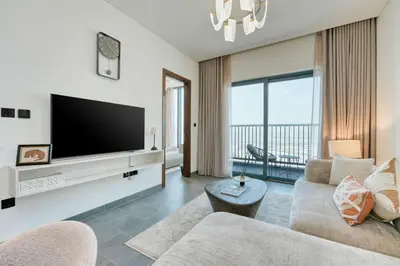 a living room with a tv and a couch at PVH Stylish Boho 1BR with Study - The Crest in Dubai