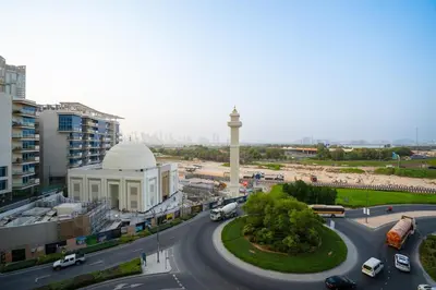 a view of a city with a mosque and a street at Crest Serene Stay for 4 Guests 1BR and Cozy Room in Dubai