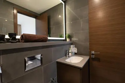 a bathroom with a sink and a mirror at Crest Serene Stay for 4 Guests 1BR and Cozy Room in Dubai