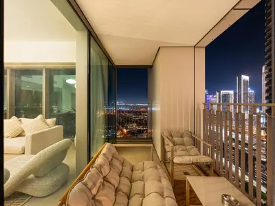 a balcony with a view of a city at night at Downtown 4BDR Apartment Opposite Dubai Mall, Burj Khalifa Views in Dubai