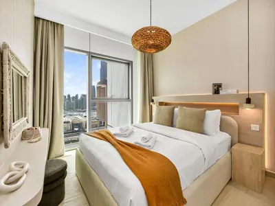 a bedroom with a large bed and a large window at Downtown 4BDR Apartment Opposite Dubai Mall, Burj Khalifa Views in Dubai
