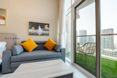 a living room with a couch and a large window at Burjkhalifa View Top Floor Dubai Mall 7Mins in Dubai