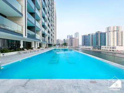 a large swimming pool on the roof of a building at Luxury 2B with Balcony & Jaccuzi in Business Bay in Dubai