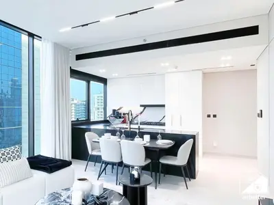 a kitchen and living room with a table and chairs at Luxury 2B with Balcony & Jaccuzi in Business Bay in Dubai
