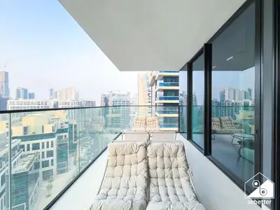 a balcony with white furniture and a view of the city at Luxury 2B with Balcony & Jaccuzi in Business Bay in Dubai