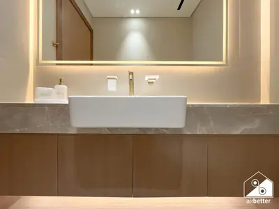 a bathroom with a white sink and a mirror at Luxury 2B with Balcony & Jaccuzi in Business Bay in Dubai