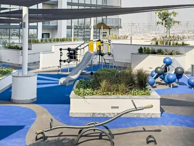 a playground on the roof of a building with a slide at Fancy 1BR apartment The Crest at Sobha Hartland in Dubai