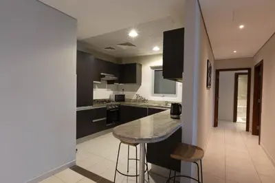 a kitchen with black cabinets and a marble counter top at Dubai Marina Marina Heights 2 beds Sleeps 4 in Dubai