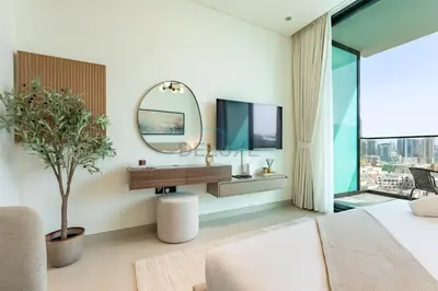 a bedroom with a mirror and a desk and a window at Studio Just Minutes Drive from Miracle Garden, Near Local Parks and Circle Mall, Binghatti Azure, JVC by Deluxe Holiday Homes in Dubai