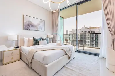 a white bedroom with a bed and a large window at Studio with Community Views, Steps from Circle Mall and Parks, Near Jebel Ali Racecourse, Binghatti Azure, JVC by Deluxe Holiday Homes in Dubai