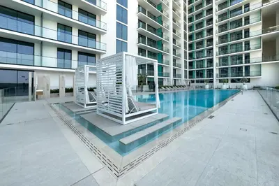 a swimming pool in the middle of a building at Studio with Community Views, Steps from Circle Mall and Parks, Near Jebel Ali Racecourse, Binghatti Azure, JVC by Deluxe Holiday Homes in Dubai