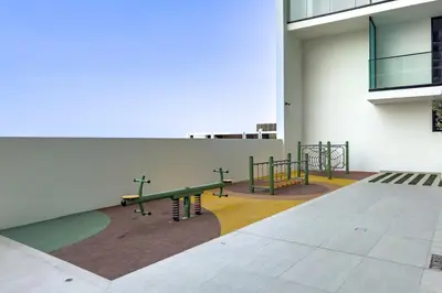 a group of benches in the side of a building at Studio with Community Views, Steps from Circle Mall and Parks, Near Jebel Ali Racecourse, Binghatti Azure, JVC by Deluxe Holiday Homes in Dubai