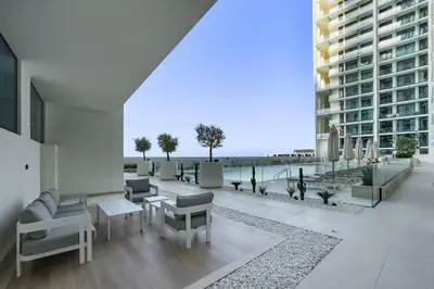 an apartment patio with a view of the ocean at Studio with Community Views, Steps from Circle Mall and Parks, Near Jebel Ali Racecourse, Binghatti Azure, JVC by Deluxe Holiday Homes in Dubai