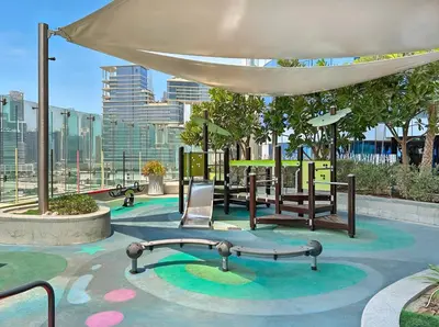 a park with a playground with a swing at TRPS - Paramount Tower D, Business Bay - Premium 1BR Furnished, High Floor, Ready Move In in Dubai