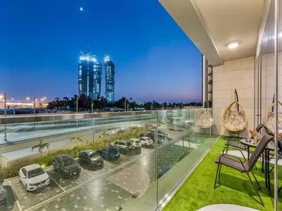 a view from the balcony of a building with cars on it at Savis Homes - Canal Front Residence Near Al Wasl Safa Park with Skyline View in Dubai