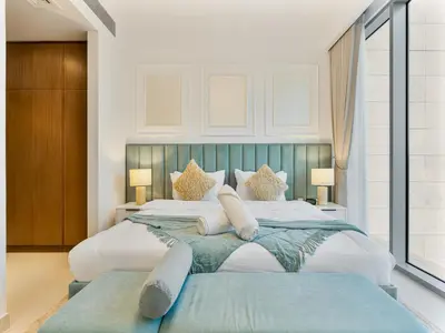 a large bedroom with two beds and two lamps at Savis Homes - Canal Front Residence Near Al Wasl Safa Park with Skyline View in Dubai