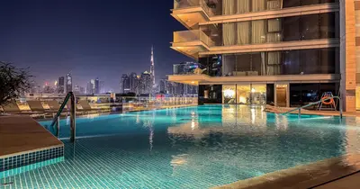 a large swimming pool on the side of a building at Savis Homes - Canal Front Residence Near Al Wasl Safa Park with Skyline View in Dubai