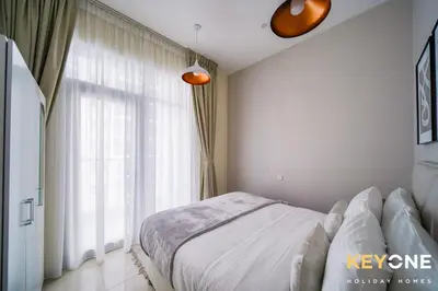 a bedroom with a bed and a large window at Magnificent Two Bedroom Beachfront in Dubai