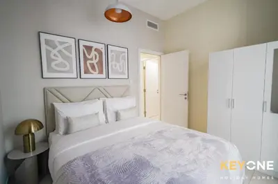 a bedroom with a large white bed with white pillows at Magnificent Two Bedroom Beachfront in Dubai