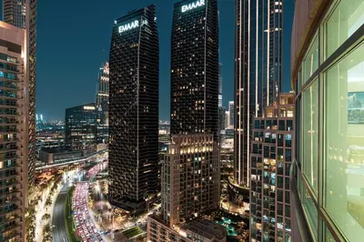 a view of a city skyline at night at Luxe 2 Bed with Burj View, 5 Min Walk to Dubai Mall, PS5 by Vista Stays Dubai Downtown in Dubai