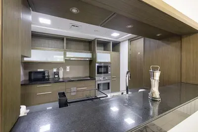 a large kitchen with a counter top in a room at Luxe 2 Bed with Burj View, 5 Min Walk to Dubai Mall, PS5 by Vista Stays Dubai Downtown in Dubai
