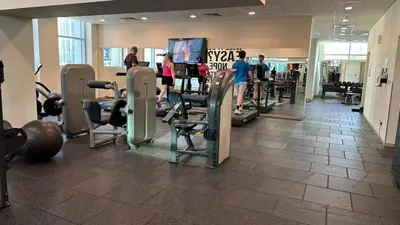 a gym with treadmills and people exercising in it at Downtown Dubai Beautiful Upgraded 1-bedroom apartment in Dubai