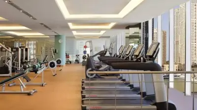 a gym with a row of treadms and machines at Daniels 1BR at JW Marriott with Marina View in Dubai
