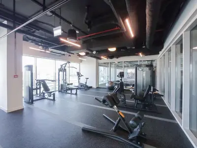 a gym with treadmills and exercise equipment in a room at StayShort - Dubai Hills sleeps 4 in a Great Location in Dubai