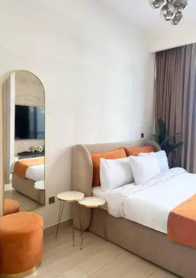 a hotel room with a bed and a mirror at Cozy Studio 15 Min From Burj Khalifa in Dubai