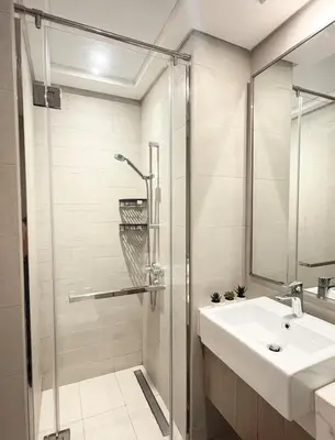a bathroom with a sink and a shower at Cozy Studio 15 Min From Burj Khalifa in Dubai