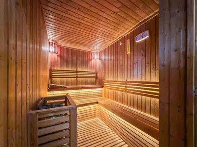 a wooden sauna with a wooden floor and wooden walls at 2 bedroom apartment with private pool in Dubai