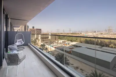 a balcony with two chairs and a view of a city at Frank Porter - Binghatti Corner in Dubai