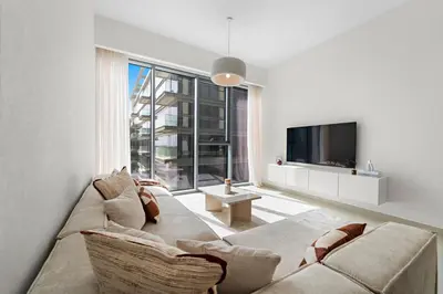 a living room with a couch and a tv at Partial Canal View 2BR plus Maid close to Safa Park in Dubai
