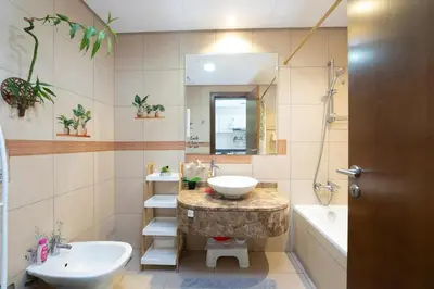 a bathroom with a sink and a toilet and a tub at Fully Furnished Studio Hilliana Tower Sea View and Burj View in Dubai
