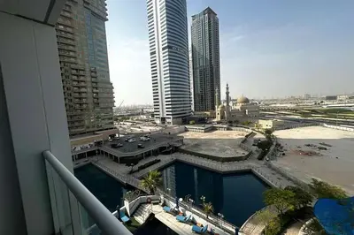 a view from a balcony of a city with tall buildings at Movenpick Apartment JLT in Dubai