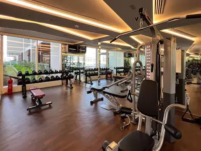 a gym with lots of treadmills and machines at Frank Porter - Jwelz Residence in Dubai