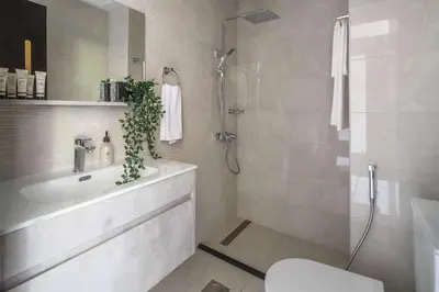 a bathroom with a shower and a sink and a toilet at Frank Porter - Jwelz Residence in Dubai