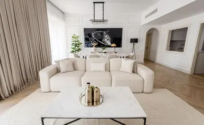 a living room with a white couch and a table at Spacious and luxurious 1 bed with amazing marina view!Rimal ! in Dubai