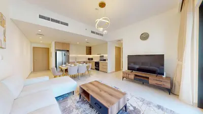 a living room with a couch and a tv and a table at Vacationer l Chic 2 Bedroom l Prime Location in Creek Harbour l Pool View in Dubai