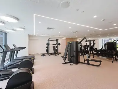 a gym with treadmills and exercise equipment in a building at Vacationer l Chic 2 Bedroom l Prime Location in Creek Harbour l Pool View in Dubai