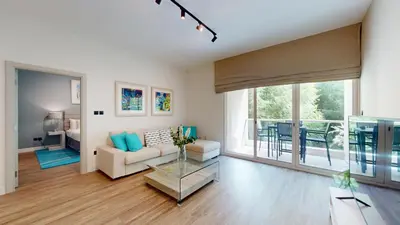 a living room with a couch and a table at Vacationer l Modern 1 Bedroom l Aesthetic Interior l Free Wi-Fi in Dubai