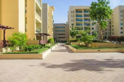 a sidewalk in a city with buildings and trees at Vacationer l Modern 1 Bedroom l Aesthetic Interior l Free Wi-Fi in Dubai