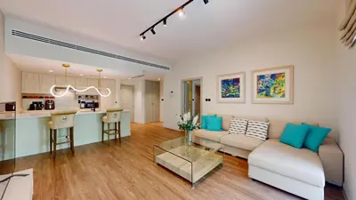 a living room with a couch and a table at Vacationer l Modern 1 Bedroom l Aesthetic Interior l Free Wi-Fi in Dubai