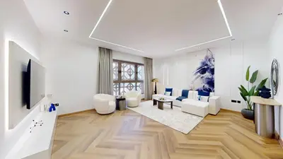 a living room with white furniture and a tv at Vacationer I Upgraded , Luxury 2 Bedroom Apartment Near JBR Beach, Prime Spot in Dubai