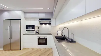 a kitchen with white cabinets and stainless steel appliances at Vacationer I Upgraded , Luxury 2 Bedroom Apartment Near JBR Beach, Prime Spot in Dubai