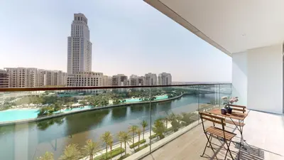 a balcony with a view of a river and buildings at Palace Residences - Two Bedroom with Creek View in Dubai